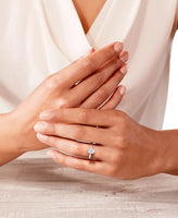 14K white gold ring featuring a 5/8 ct oval-cut diamond solitaire on a hand model's finger