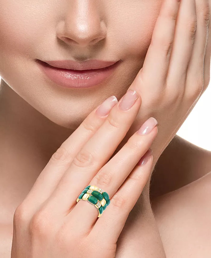 Close-up of a woman's hand wearing a triple-row 14K gold ring with malachite and diamond accents.