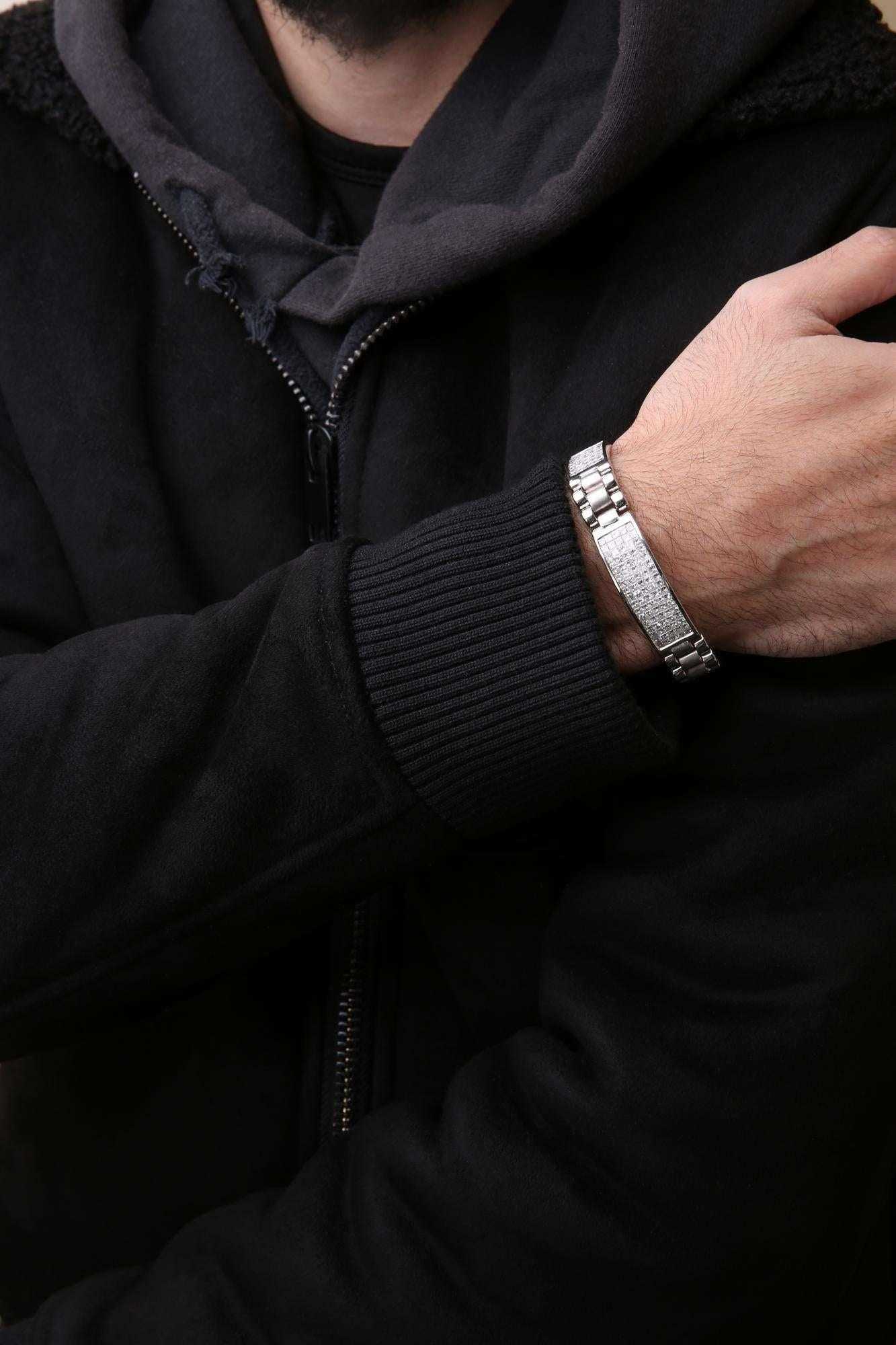 Men's wrist wearing a 14K white gold princess diamond tennis bracelet with princess cut diamonds, size 8.5 inches