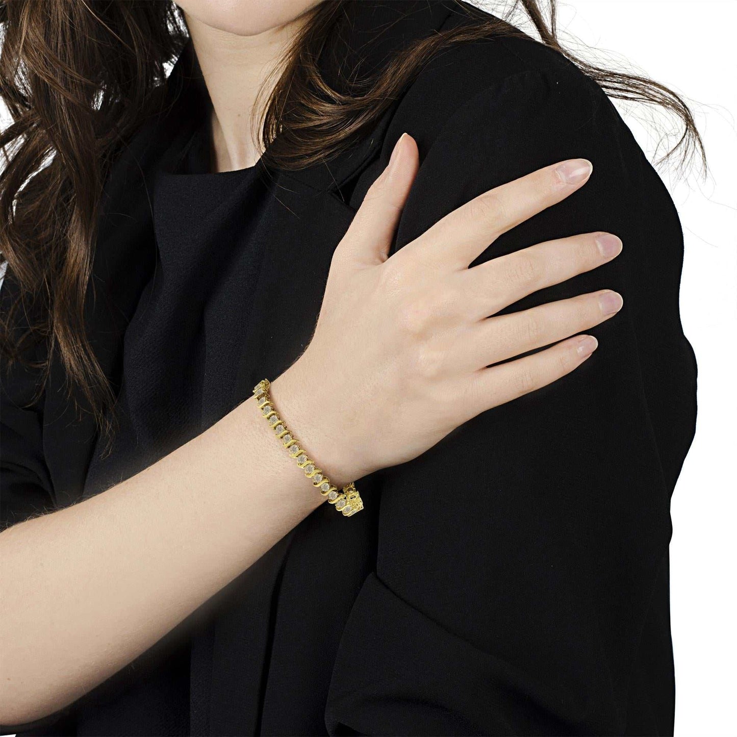 Prong set round brilliant cut diamond S-link bracelet in 10K yellow gold coated sterling silver worn on wrist