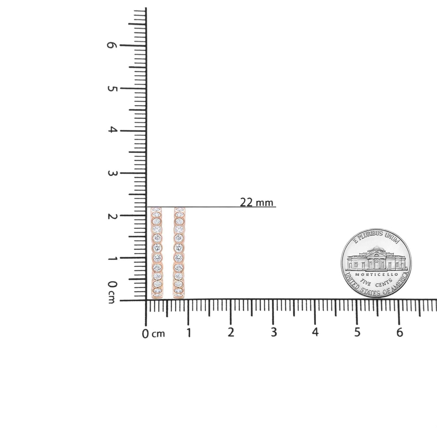 18K rose gold round bezel-set diamond hoop earrings next to ruler and coin for size comparison
