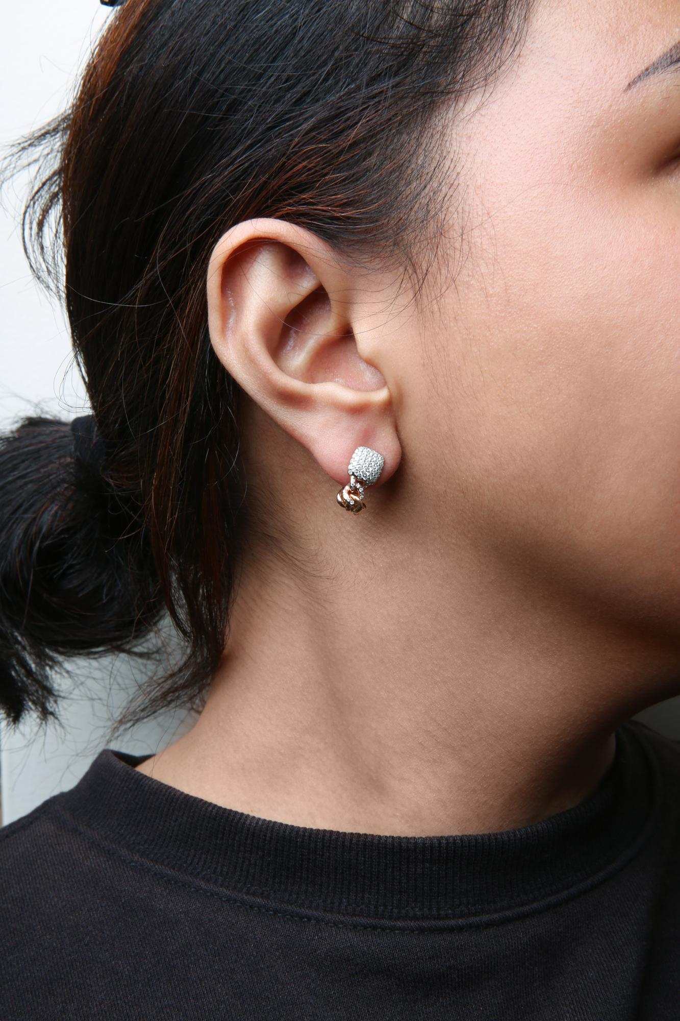 18K rose gold round diamond pave Cuban chain huggie earrings worn on ear