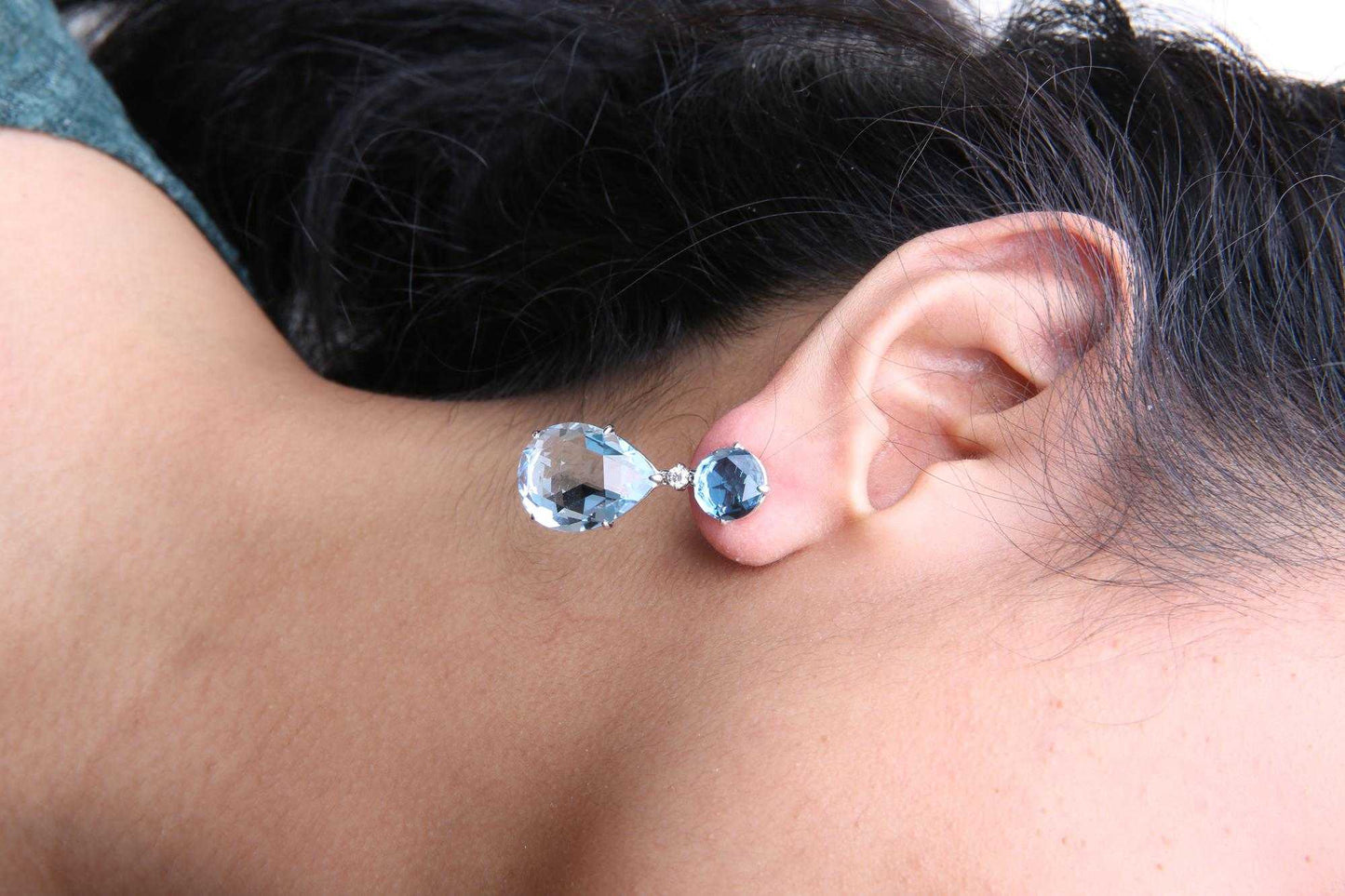18K white gold dangle earrings with round London blue topaz, 1/5 cttw diamonds, and pear cut sky blue topaz gemstones