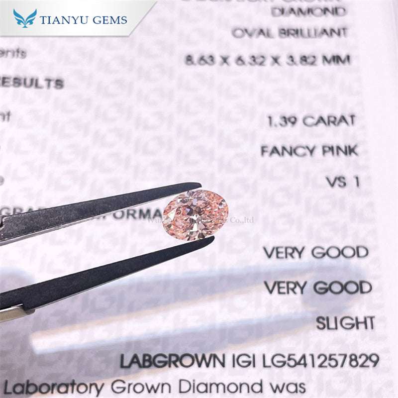 Cherry pink pear oval lab grown diamond held by tweezers with certification details in background