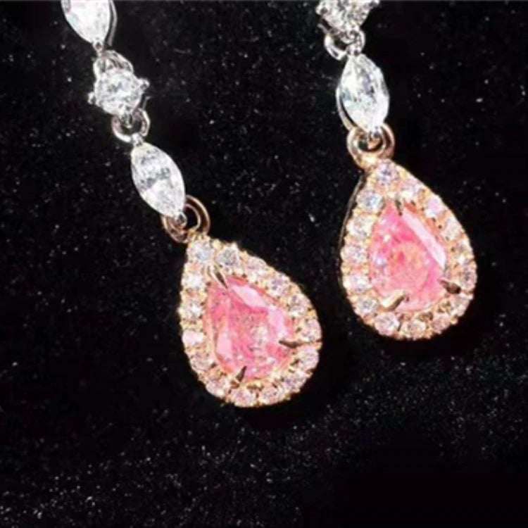 Pair of elegant drop earrings featuring 0.34ct natural pink diamonds surrounded by smaller white diamonds in a delicate white gold setting.