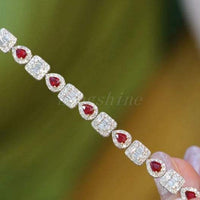 Pear shape ruby and baguette diamond square bracelet with alternating red pear-shaped rubies and sparkling diamond squares