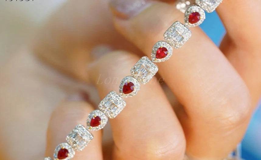 Pear shape ruby and baguette diamond square bracelet on hand