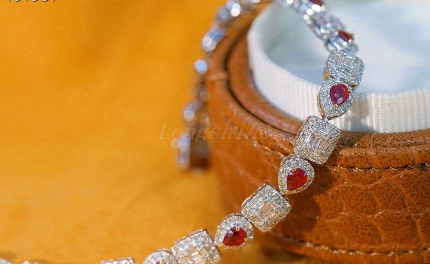 Pear shape ruby and baguette diamond square bracelet on leather jewelry box