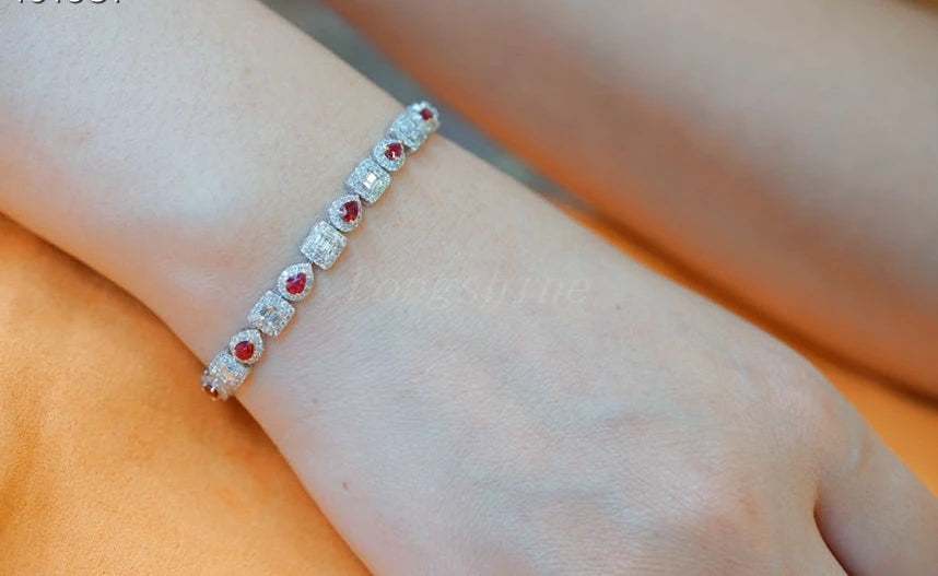 Pear shape ruby and baguette diamond square bracelet on wrist