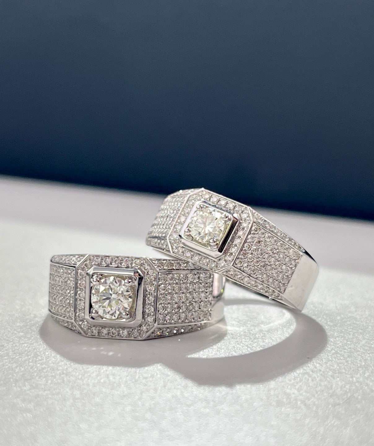 Two exquisite paved bling wedding men rings with central square diamond on silver bands