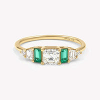 Hall of Emerald Ring featuring 14k yellow gold band with Asscher-cut diamond center and rectangular emerald accents