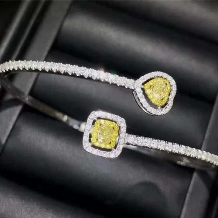 18k gold bangle bracelet with natural yellow diamond charm and surrounding white diamonds