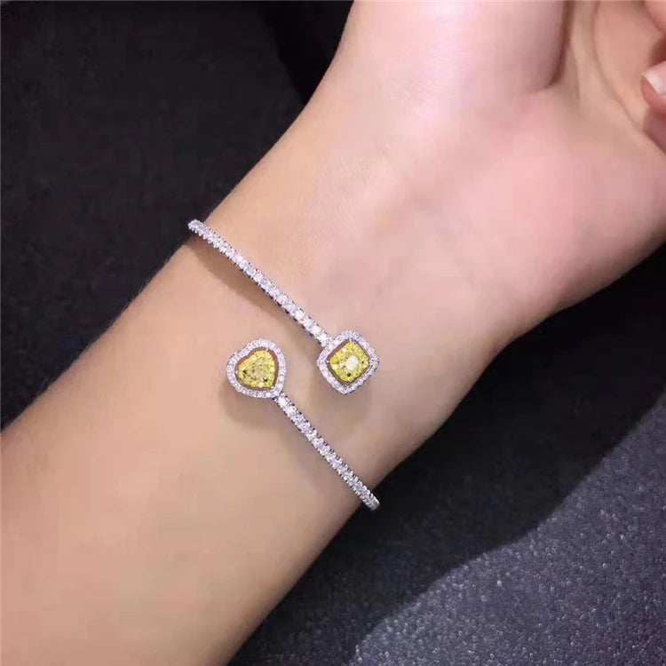 18k gold bangle bracelet with natural yellow diamond charms on wrist