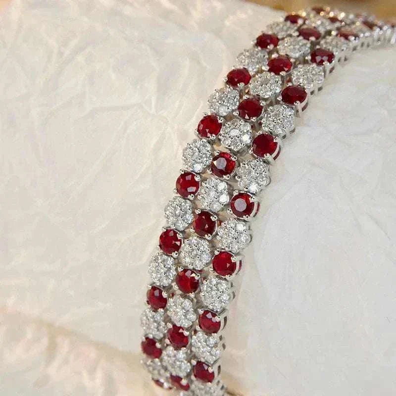 18K white gold tennis bracelet with alternating natural rubies and sparkling diamonds in a three-row design
