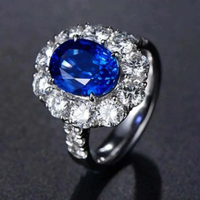 White gold ring with a natural blue sapphire center stone surrounded by sparkling diamonds, called the Star of Ithil.