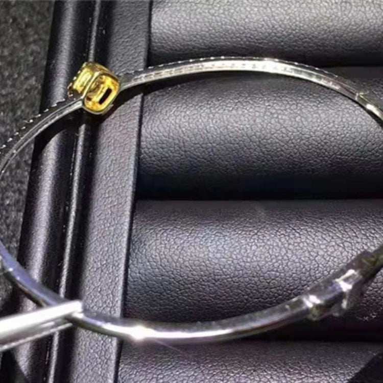 18K gold bangle featuring a 0.364ct natural yellow diamond on a black textured background