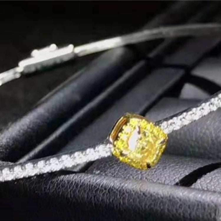 18K gold bangle with a 0.364ct natural yellow diamond and white diamond accents