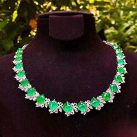 Diadem of the Verdant Dawn 18K white gold necklace with 44.32 ct vivid green emeralds and diamond accents on black display bust
