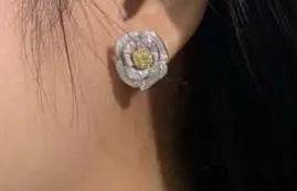 Close-up of a delicate rose-shaped earring from the Valentine Love Serial Rose Jewelry Set featuring natural diamonds and intricate gold detailing.
