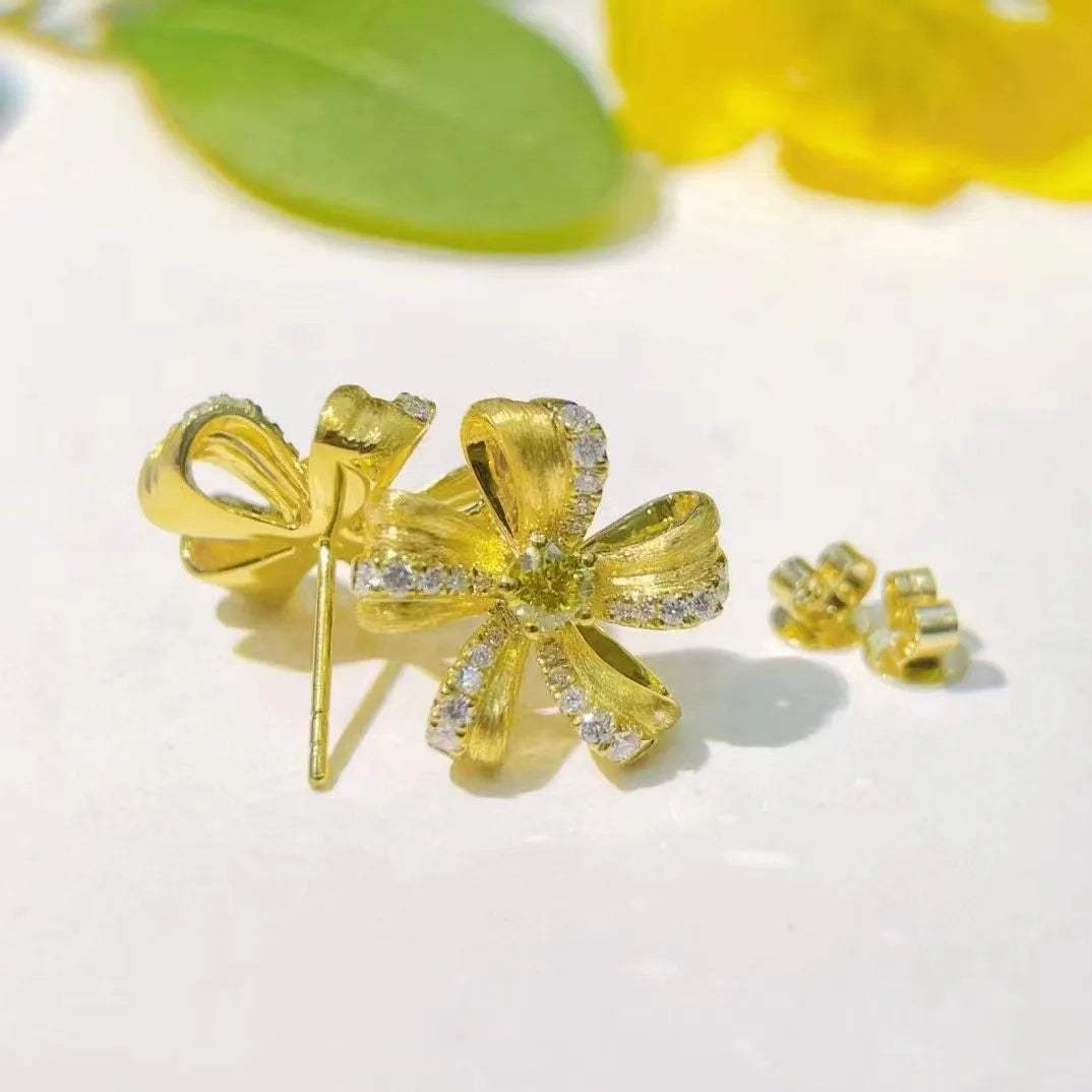 Natural yellow diamond floral stud earrings in 18K gold with 0.39ct yellow diamonds and diamond accents