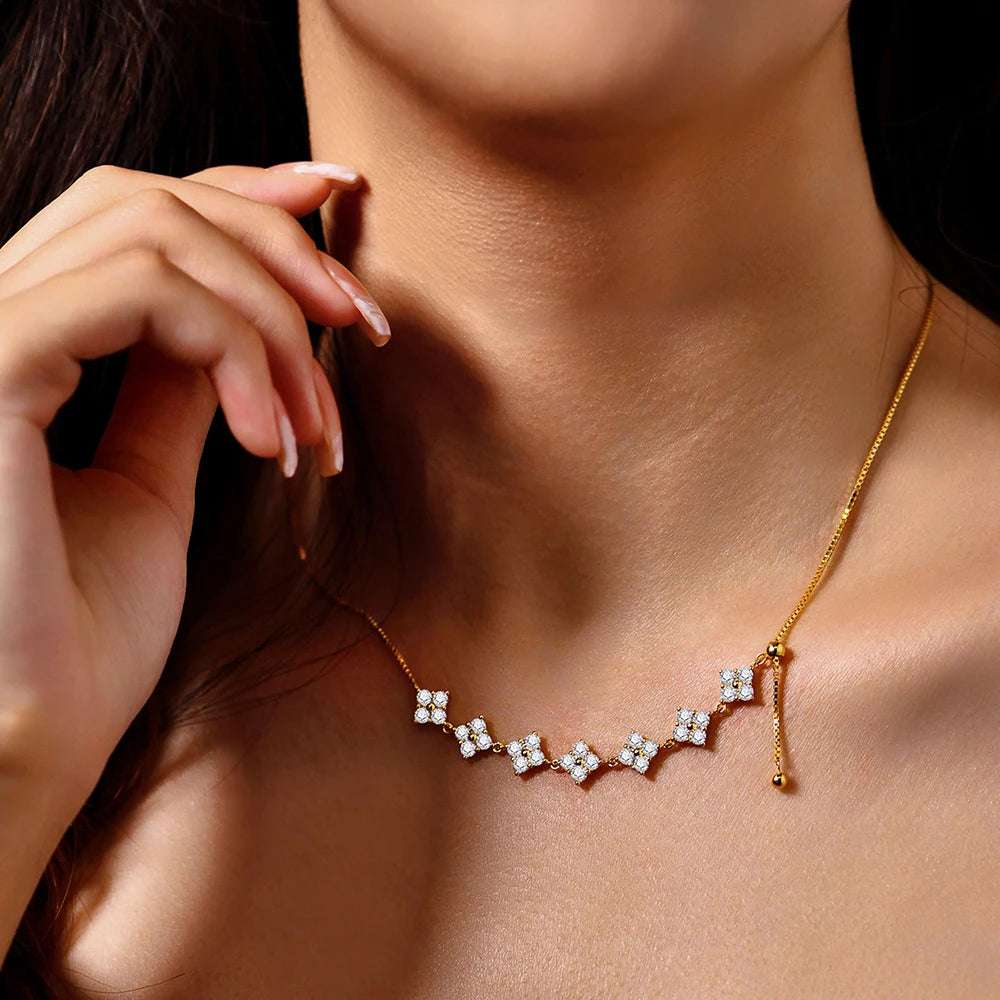 Close-up of a woman wearing a D-Color Moissanite Bridal Necklace with a sterling silver and gold pendant featuring round VVS1 moissanite stones.