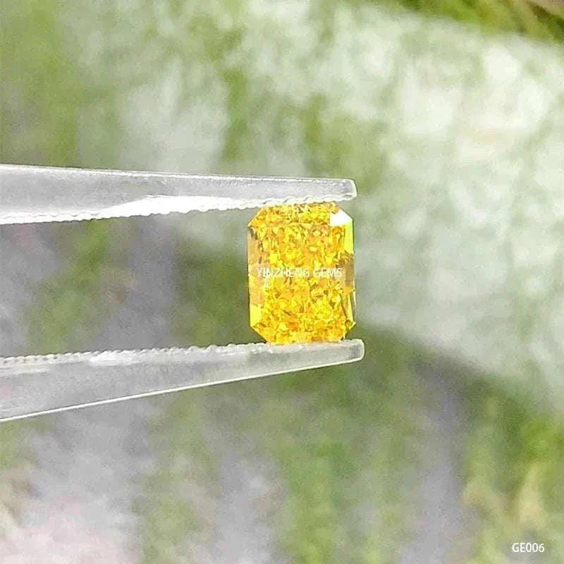3.55 carat radiant cut fancy vivid yellow lab-grown diamond called the Aurelion Shard held by tweezers against a blurred green background