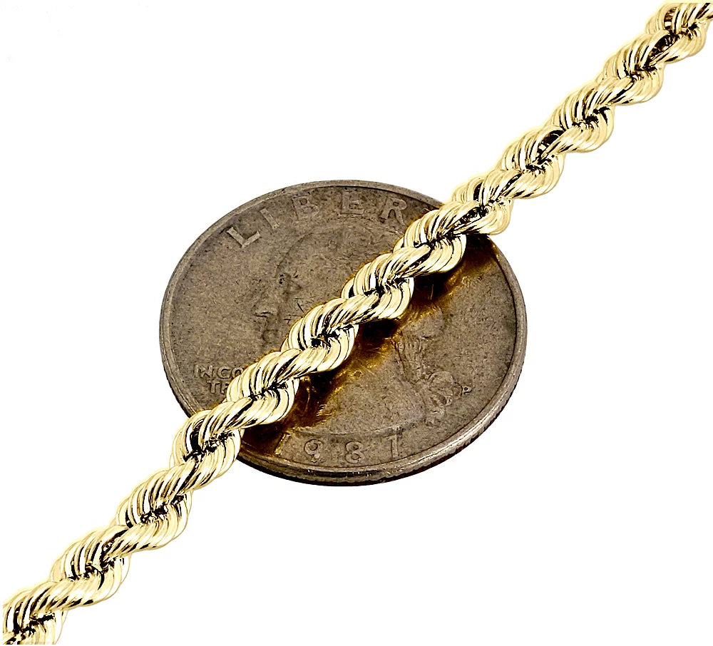 18K yellow gold 4mm diamond cut solid rope chain necklace displayed over a coin for size comparison