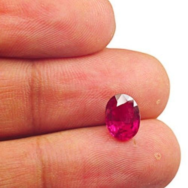 2.27 ct GIA-certified untreated Mozambique neon pink ruby called Ember of Nyx displayed on fingertip