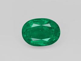 Deep green oval-shaped 5.47 carat natural Zambian emerald gemstone certified by GII