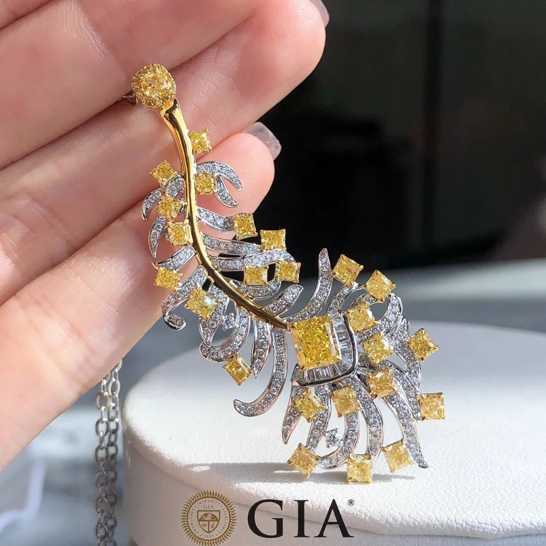 Sun-Enchanted Elven Brooch in 18K white gold with 0.73 ct natural yellow diamonds, featuring an intricate elven leaf design and sunburst motif.
