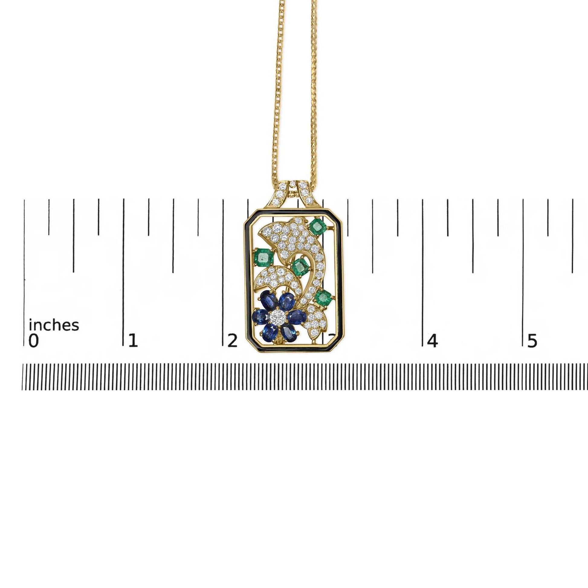 Oceanheart Sigil pendant in 18K yellow gold with diamonds, sapphires, emeralds, and dolphin silhouette on an 18-inch chain.