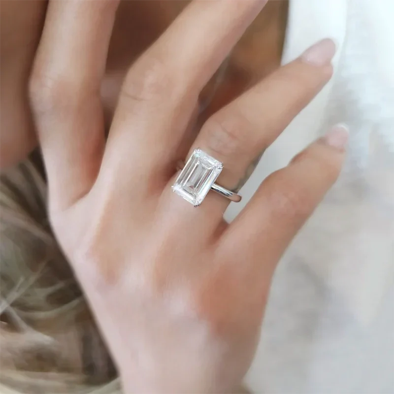 Hand wearing Eternity Prism emerald-cut diamond ring in silver setting