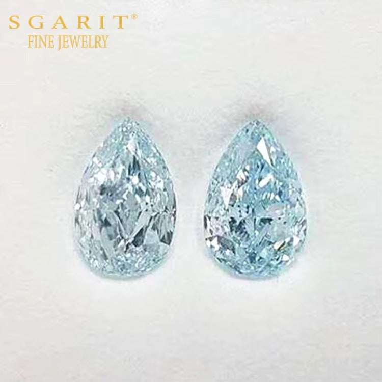 Pair of SGARIT Naiad’s Tears greenish-blue pear-shaped diamonds, 7.39 ct total, GIA VVS2 certified, finely cut for brilliance.