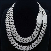 Double-layered Cuban link chain in S925 silver with VVS moissanite diamond accents on a black display bust