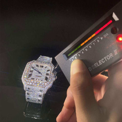 Fully iced out hand-setting VVS moissanite diamond luxury watch with square face and Roman numerals displayed with diamond tester.