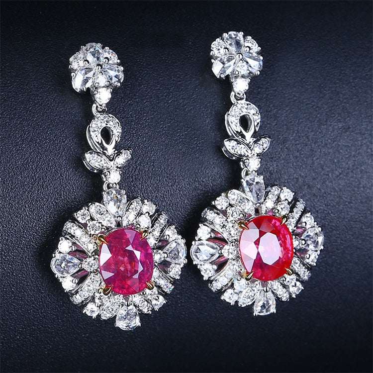 18k gold drop earrings with 2.31ct untreated red rubies surrounded by sparkling white diamonds, inspired by The Tears of the Firebird legend.