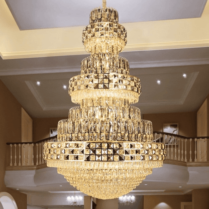 Grand multi-tiered crystal chandelier named Celestial Crown of Eärendil™ glowing with golden light in a luxurious interior.