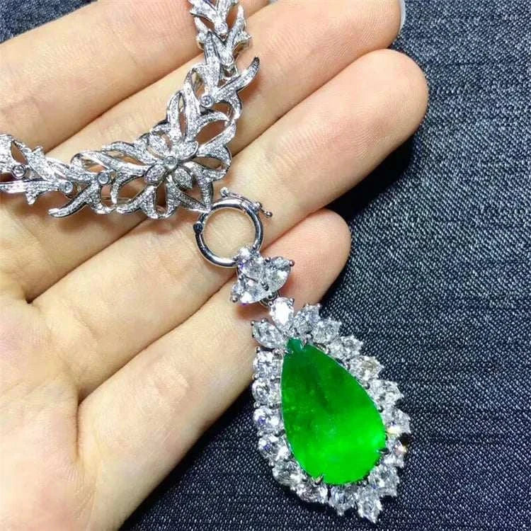 Heart of the Enchanted Forest 18K gold necklace with a 12.78ct vivid green emerald pendant surrounded by sparkling diamonds