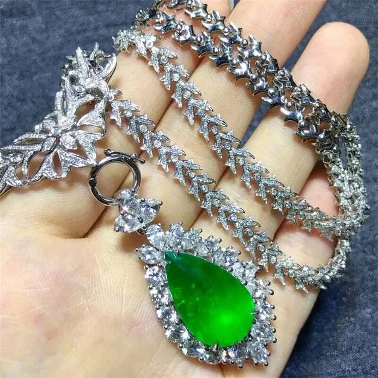 Heart of the Enchanted Forest 18K gold necklace with 12.78ct green emerald teardrop pendant surrounded by diamonds