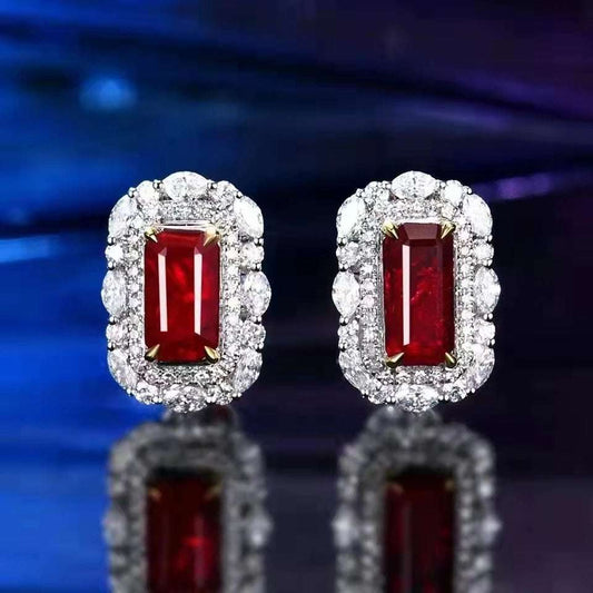 Phoenix Tears of Valyria earrings featuring rectangular pigeon blood rubies surrounded by white gold and diamond halo settings.