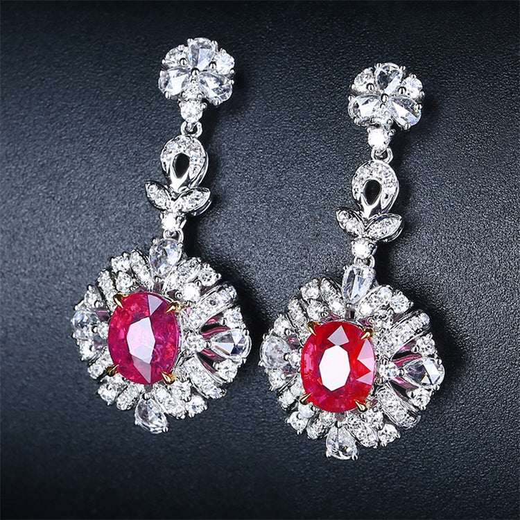 Elegant 18k gold drop earrings featuring 2.31ct unheated red rubies surrounded by sparkling white gemstones, inspired by The Tears of the Firebird.