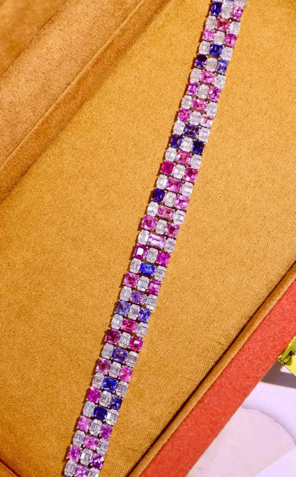 The Rosefire Legacy 18K gold bracelet with natural pink sapphires and purple gems in a rectangular design