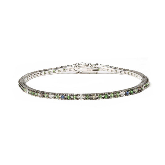 18K white gold tennis bracelet with blue sapphires, green tsavorite gemstones, and 3/8 CTTW diamonds in prong settings.