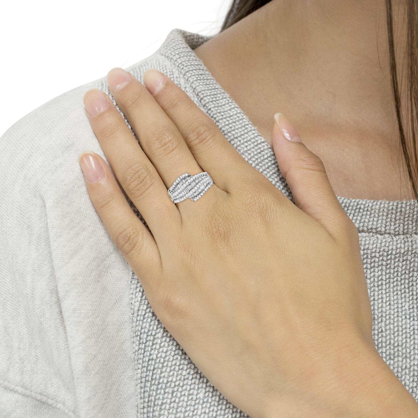 Diamond cocktail ring band with seven rows of round and baguette diamonds in 14k white gold on a woman's hand