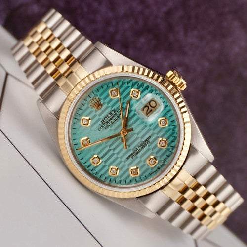 Rolex Date-just of the Azure Aegis watch with blue patterned dial, gold bezel, and two-tone Jubilee bracelet