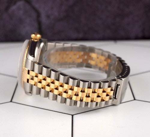 Close-up of the Date-just of the Azure Aegis watch showing its gold and steel Jubilee bracelet and part of the Oystersteel case.