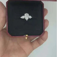 14k gold ring featuring a 3ct pear-shaped diamond named The Tear of the Moon Queen in a red velvet box