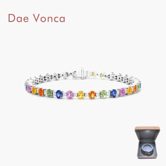 Silver tennis bracelet with multicolored gemstones and a jewelry box