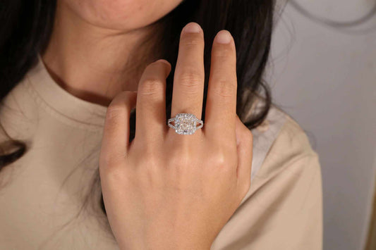 Lothlórien's Moonlit Whisper diamond band with 5.0ct cushion-cut center and 14k white gold halo setting on finger