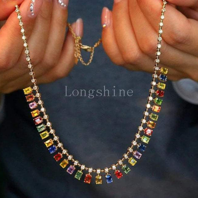 18K gold yellow color chain necklace with multicolored rectangular gemstones held by hands